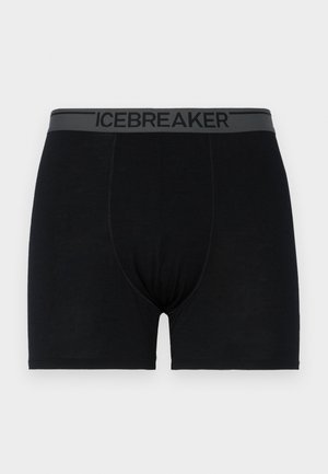 Boxer shorts negros hechos de una tela suave con una cinturilla elástica gris que presenta el nombre de la marca "ICEBREAKER" impreso en negro.