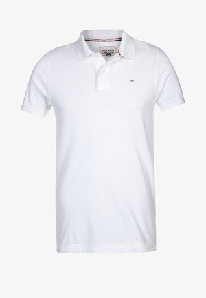 Polo blanc à manches courtes avec col et patte à deux boutons, avec petit logo drapeau Tommy Hilfiger sur la poitrine gauche.