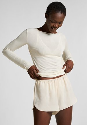 Lightweight long-sleeve cream top and matching cream shorts, featuring a soft texture, relaxed fit, and elastic waistband.