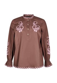 Blusa di cotone marrone con ricami floreali rosa, scollo arricciato, patta con bottoni e polsini arricciati; dettaglio dell'orlo scallop.