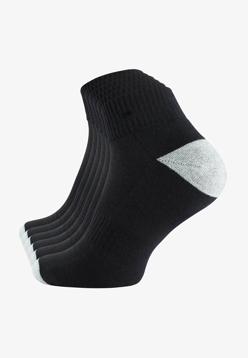 Calze nere alla caviglia con un design a coste testurizzate e un accento bianco sul tallone. Tessuto liscio con una leggera lucentezza, presentato in un'impilatura.