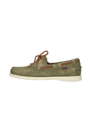Zapato náutico de ante verde oliva con suela blanca, cordones de cuero marrón, ojales laterales y pequeña etiqueta de tela con la marca en el lado del talón.