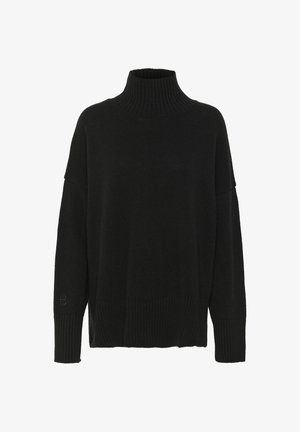Mustmustard mustreppimisee kaelusega must lõngakootud sviiter, millel on lahtine lõige, soonikkoes kaelus ja mansetid. Kehale on lisatud tekstuuriline muster ning varrukal on logo detail.