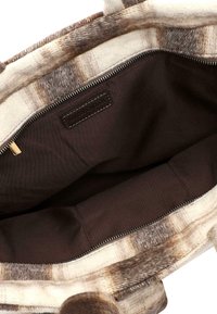 Brown and beige plaid tote bag with a soft felt exterior, featuring a dark brown fabric interior and metallic zipper detail.