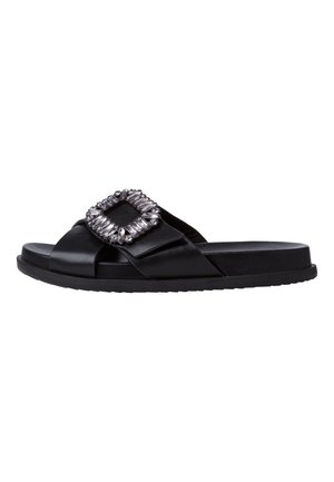 Black slide sandal with a textured synthetic upper, featuring a large embellished square buckle detail. Sleek flat sole design.