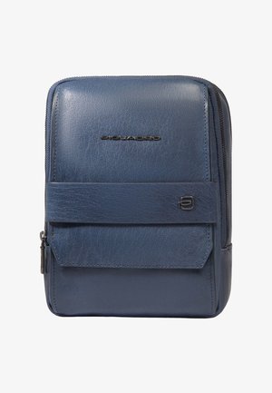 Compact blue leather crossbody bag with front flap pocket, zipper closure, and subtle metal logo details.
