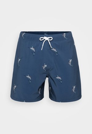 Tengerész stílusú fürdőnadrág gyorsan száradó anyagból, amelyet mindenhol hímzett halmintázat díszít. Rugalmas derékpánt húzózsinórral.