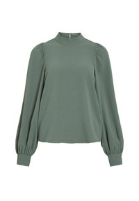 Blouse à manches courtes et col montant en vert pâle. Présente des manches bouffantes et un tissu texturé avec une fermeture éclair au dos.