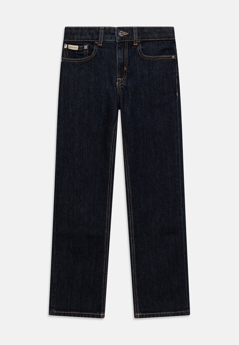 Tamsiai mėlyni džinsai su tiesiomis kojomis, kontrastingos oranžinės siūlės, metalinis mygtukas ir mažas prekės ženklas ant užpakalinės kišenės.