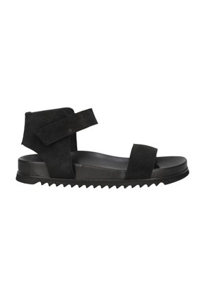 Black suede sandal with two wide straps, adjustable Velcro, and a contoured sole featuring textured grooves for grip.
