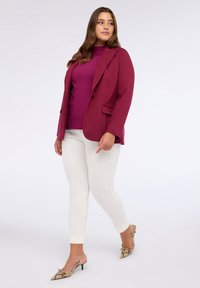 Burgundská sako, fialový pletený svetr, bílé slim kalhoty a lodičky se vzorem hadí kůže. Sako má jeden knoflík a dvě kapsy.