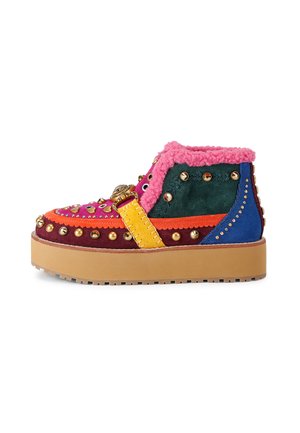 Colorful platform boots featuring multicolored suede, rounded toe, and decorative studs. Pink faux fur collar and decorative strap detail.