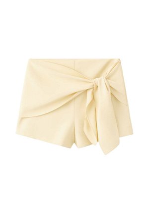 Shorts da donna color crema con vita alta e un grande fiocco in tessuto sul lato anteriore destro.
