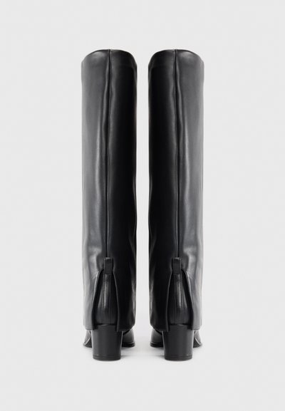 Black leather knee-high boots with a square toe, slightly textured finish, block heels, and zippers at the back for style and fit adjustment.