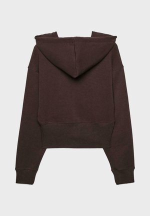 Beskurven lila hoodie i mjukt material, med huva, långa ärmar och ribbad nederkant. Minimalistisk design utan synliga logotyper eller mönster.
