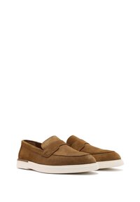 Brown suede slip-on shoes with a smooth texture, a rounded toe, and a white rubber sole, featuring a subtle stitched detail at the front.