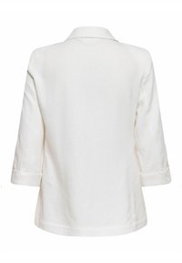 Chemise blanche à manches longues avec col, vue de dos, avec une coupe décontractée et un ourlet droit.