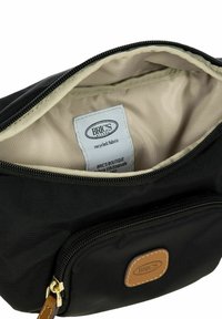 Borsa nera in tessuto riciclato con chiusura a zip, interno beige e una piccola tasca frontale con un accento in pelle marrone.