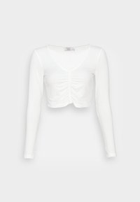 Valkoinen pitkähihainen crop-top, joka on valmistettu ribbatusta kankaasta. Sen etuosassa on V-pääntie ja rypytyksiä tekstuurin ja muotoilun yksityiskohtana.