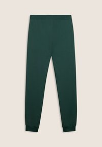 Pantalones jogger slim fit de color verde oscuro con cintura y puños elásticos, exhibidos planos sobre un fondo beige.