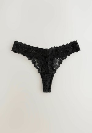 Zwarte kanten string met bloemmotieven, golvende randen en een sheer textuur, ontworpen met een minimale bedekking aan de achterkant en een delicate tailleband.
