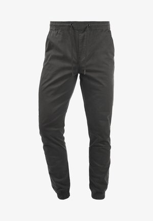 Schwarze Jogginghose mit elastischem Bund und Kordelzug, zulaufenden Beinen, Seitentaschen und elastischen Bündchen.