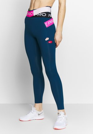 Navy blue leggings with a wide black and pink waistband, red Nike logos on hip and thigh, smooth texture, fitted design.