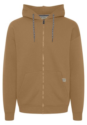 Brūna zip-up kapuce, izgatavota no mīkstas auduma, ar kapuci ar saitēm un zilu un baltu akcentu, kā arī divām priekšējām kabatām.