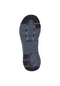 Suela de zapato de goma negra con un patrón texturizado, que presenta múltiples surcos y secciones elevadas para tracción y soporte.