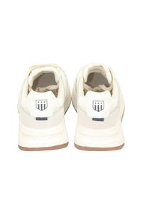 Weiße Sneaker mit einer glatten Leder-Oberfläche und hellgrauen Wildleder-Akzenten. Mit Gummisohle und einem Logo-Emblem an der Ferse.