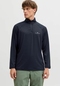 Must musta varrukatega pullover kõrge kaelusega ja pool-zipiga. Kerge kangas, millel on rindkere peal logo ja raglan varrukad.
