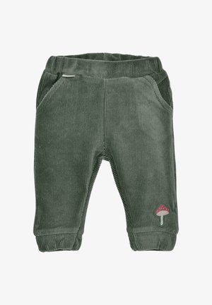 Grüne Cordhosen mit elastischem Bund, zwei seitlichen Taschen und einem Pilz-Patch-Detail am unteren linken Bein. Weicher Stoff, taillierte Passform.