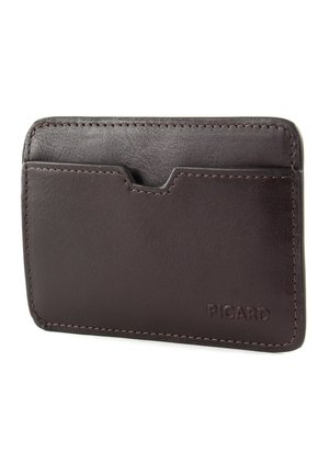 Brown leather cardholder with a smooth texture, rounded edges, and a front slot. Features visible stitching and a logo on the bottom right.