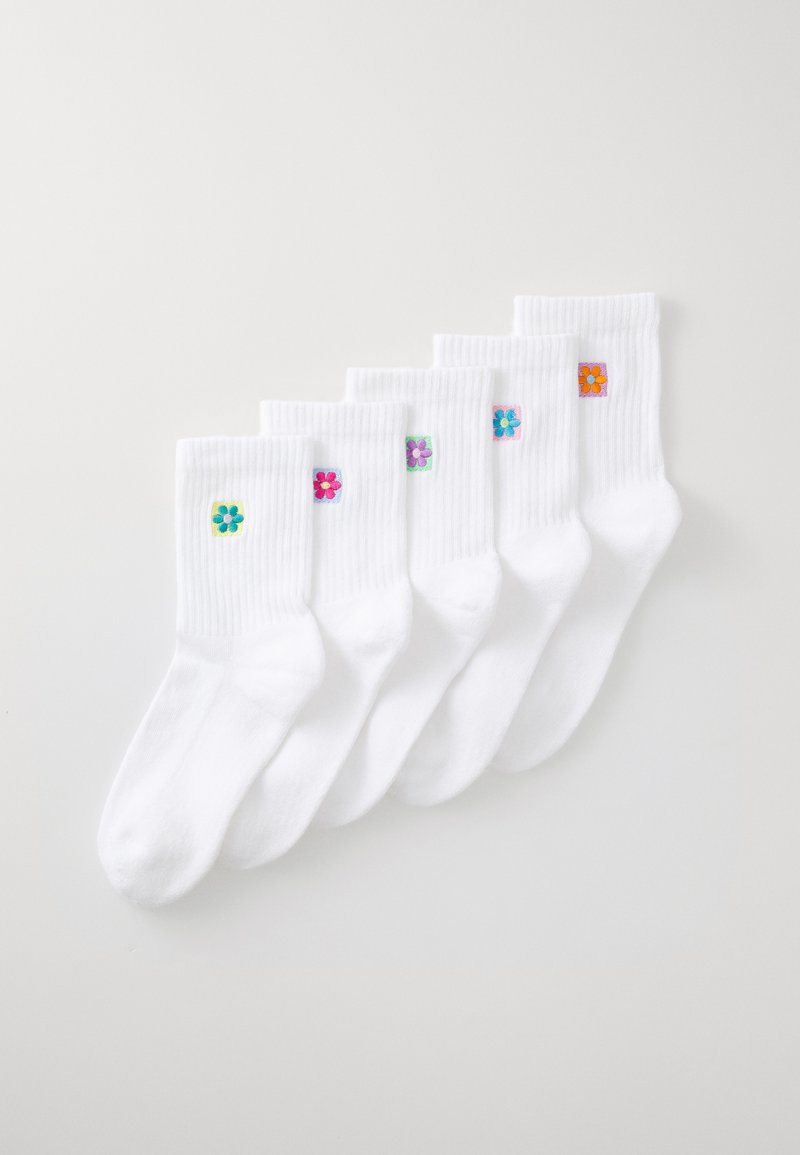 White cotton socks featuring five pairs, each with a unique embroidered flower in varied colors on a square patch. Textured ribbed cuffs.