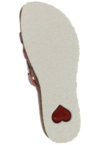 Brown sandal sole with white textured rubber, featuring a heart-shaped accent in red and decorative swirling patterns.