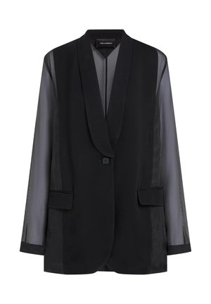 Veste noire avec un unique bouton devant, manches longues semi-transparentes, poches à rabat et col châle.