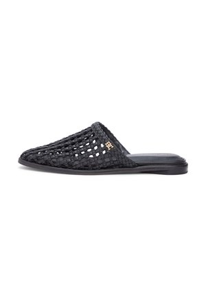 Black woven leather slip-on mule with flat sole and small gold decorative logo on upper side.