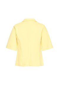 Blazer à manches courtes de couleur jaune clair avec col, montré de dos, avec une coupe ajustée et des coutures nettes.