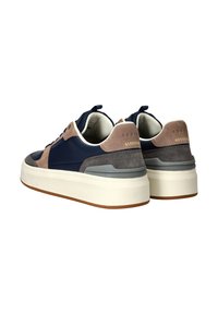 Navy and beige leather sneakers with white soles, featuring a textured design, suede accents, and a pull tab at the back.