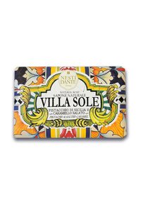 Natural soap bar with colorful floral and geometric pattern. Features a label reading "VILLA SOLE" and notes of pistachio and salted caramel.