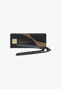 Mini lisseur de cheveux professionnel avec plaques fines en noir avec des accents dorés. Livré avec une boîte élégante arborant un design en vagues dorées.