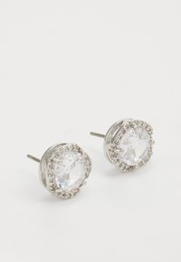 Silver stud earrings featuring large, round, faceted clear crystals surrounded by smaller sparkling accents.
