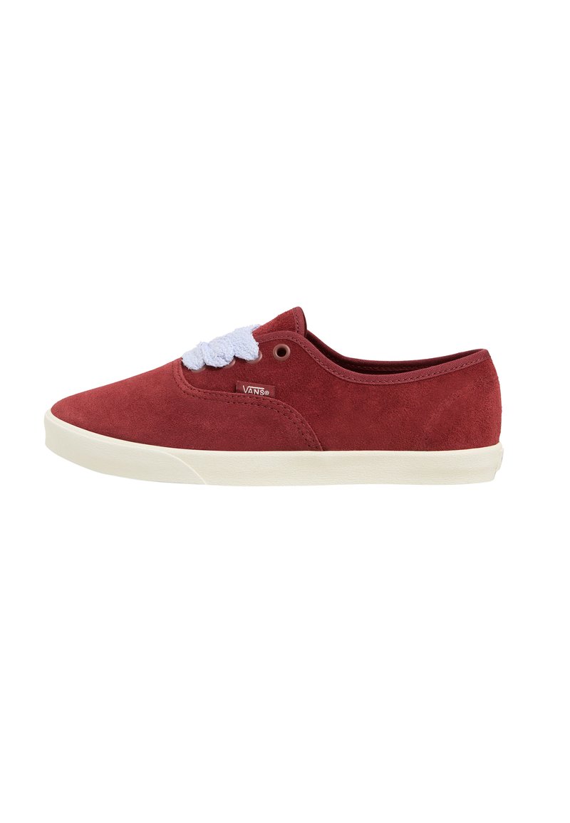 Red suede sneaker with a low profile, white laces, and a beige rubber sole. Side logo detail near the lace area.