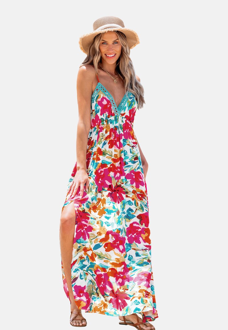 Robe maxi à motif floral avec des couleurs rouge, rose et turquoise. Elle possède un décolleté en V, des bretelles ajustables et des fentes sur les côtés pour la ventilation.
