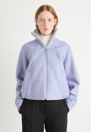 Light purple zip-up jacket with a high collar, designed in a soft fabric. Features side pockets and contrasting gray collar trim.
