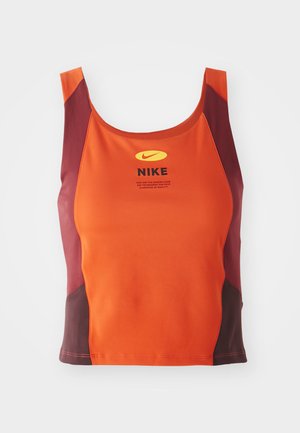 Orange and maroon athletic crop top, made of textured fabric, featuring a round neckline, Nike logo, and contrasting side panels.