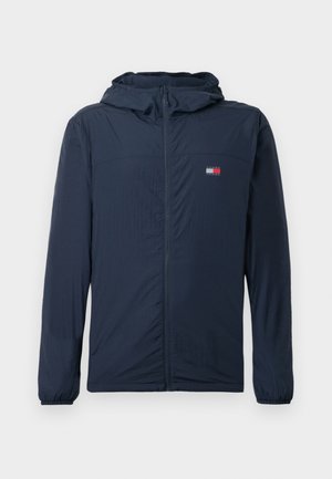 Marineblaue Kapuzenjacke mit durchgehendem Reißverschluss, elastischen Bündchen und einem kleinen rechteckigen Logo auf der linken Brust.