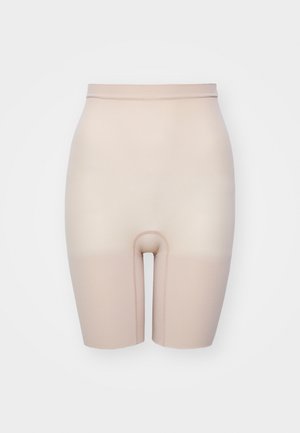 Nude, stretchy shapewear shorts with a high waist. Features a smooth texture and a central opening, designed for comfort and support.