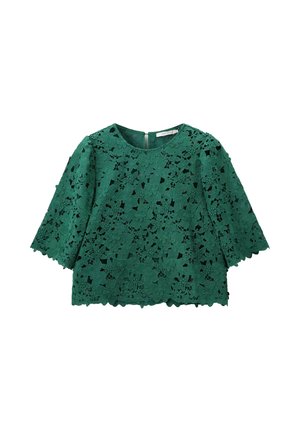 Haut en dentelle verte avec motif floral, manches trois-quarts et ourlet festonné. Fermeture éclair au dos. Conçu en tissu texturé.