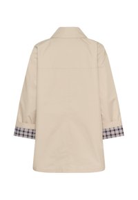 Veste beige à manches longues vue de dos, avec un col et des poignets retournés à motif à carreaux.